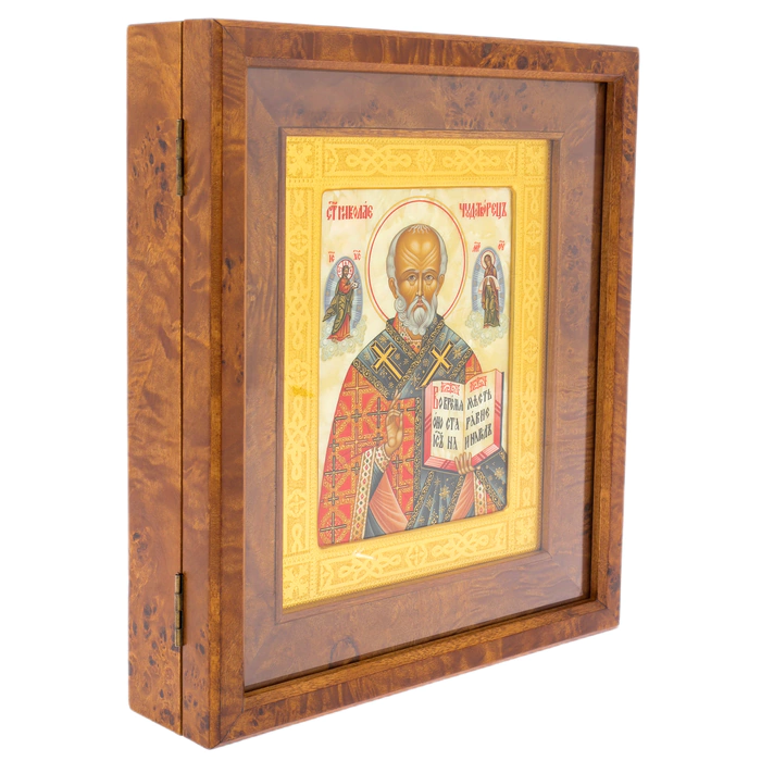 The icon of St. Nicholas the Wonderworker in a kiosk and a gold frame on natural mother-of-pearl