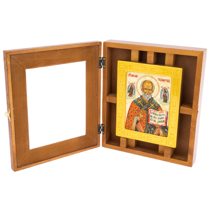 The icon of St. Nicholas the Wonderworker in a kiosk and a gold frame on natural mother-of-pearl