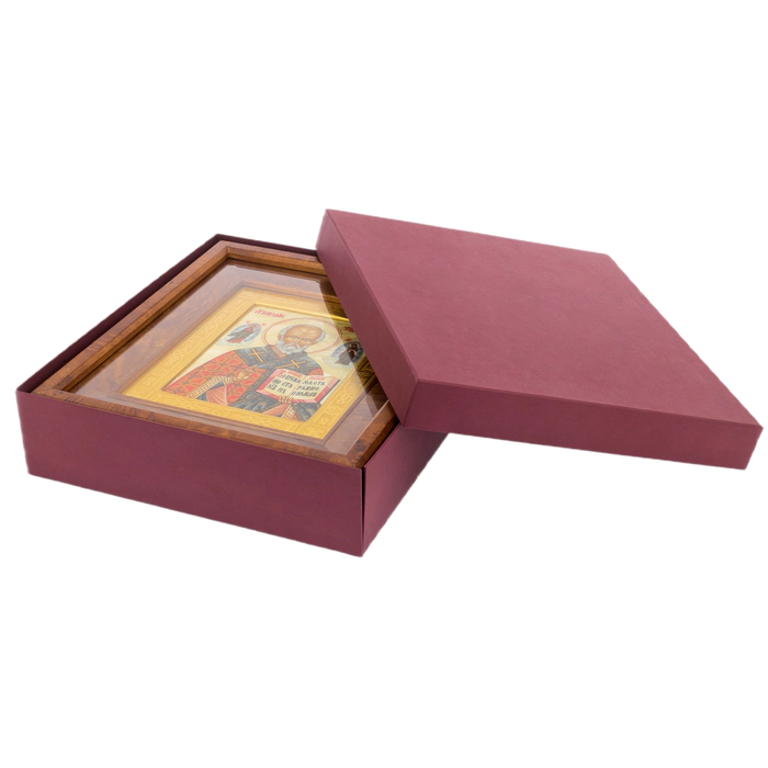 The icon of St. Nicholas the Wonderworker in a kiosk and a gold frame on natural mother-of-pearl