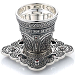 A glass for holy water with a saucer
