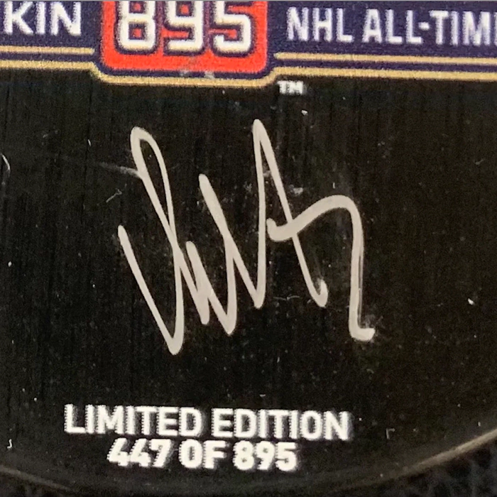 An autographed puck by hockey player Alexander Ovechkin