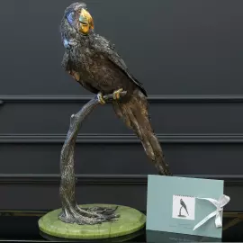 Silver sculpture "Parrot" on a marble stand