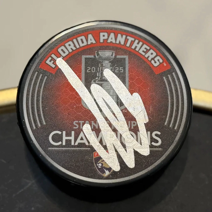 An autographed puck by hockey player Alexander Barkov