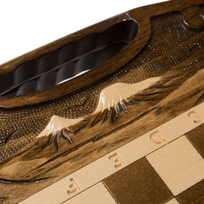 A small carved "Mountain Peaks" game set (chess, backgammon and checkers) with a handle